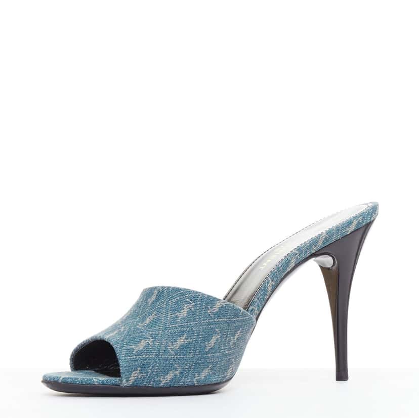 Saint Laurent Step into effortless Parisian chic with these YSL Cassandre mules, featuring all-over tonal YSL logo embroidery in washed denim and a sleek stiletto heel. Blue Denim Very good condition - Model View