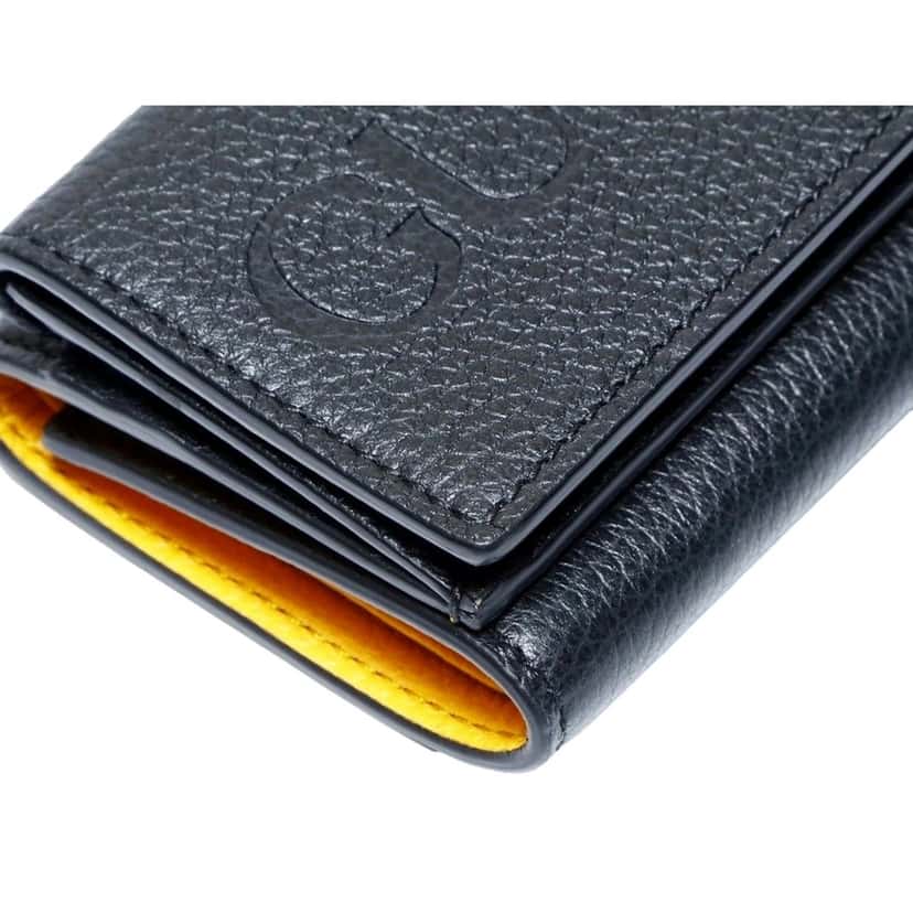 Gucci Gucci Embossed Logo Mini Tri-Fold Wallet Black Yellow Pebbled Leather Black Leather Never worn - Model View