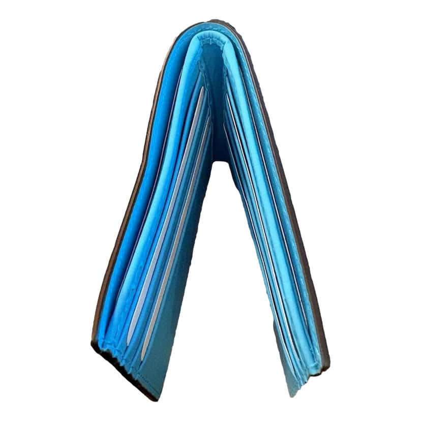 Gucci Gucci GG Embossed Leather Bifold Wallet in Neon Blue Rubber Effect Finish Blue Leather Never worn - Model View