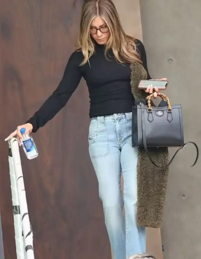 Jennifer Aniston on an outing sporting one of the most iconic Gucci handbags, the Diana