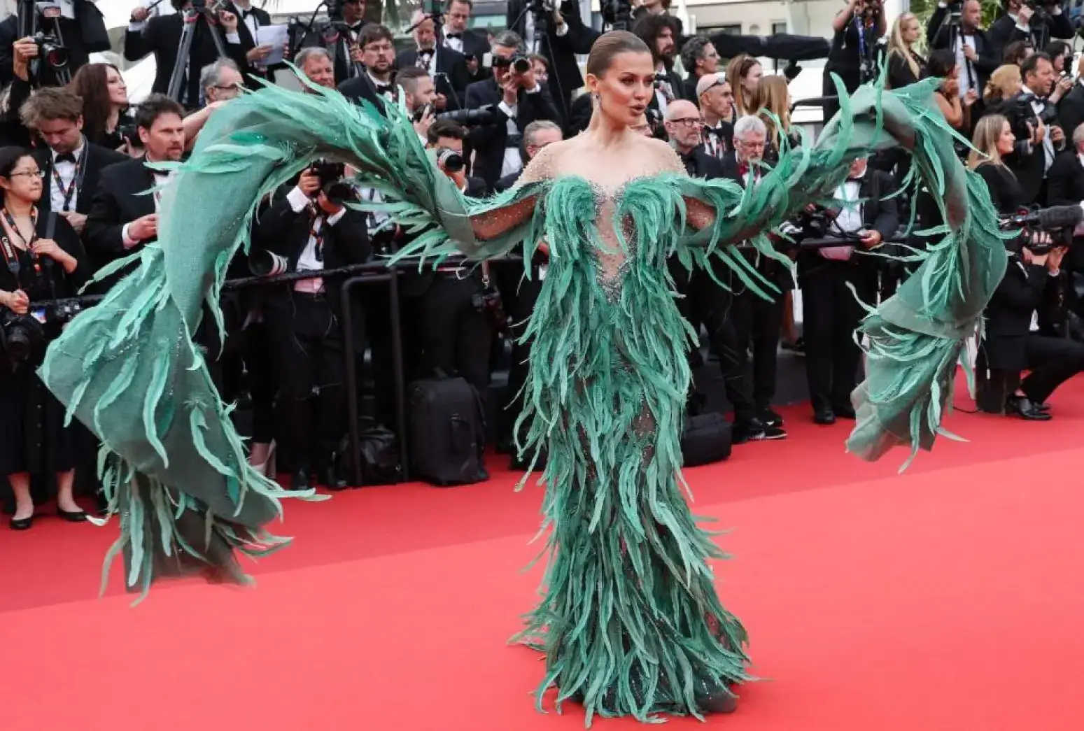 Victoria Bonya at the 76th annual Cannes film festival, donning a feather-filled Ziad Nakad gown on the red carpet. 
